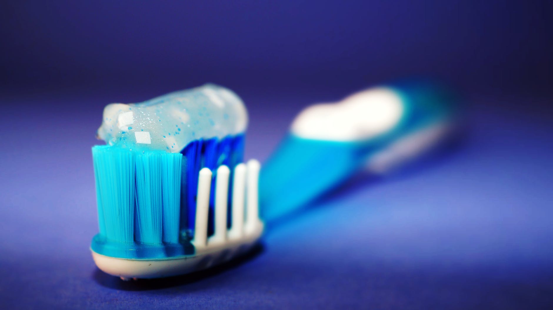 closeup and selective focus photography of toothbrush with toothpaste